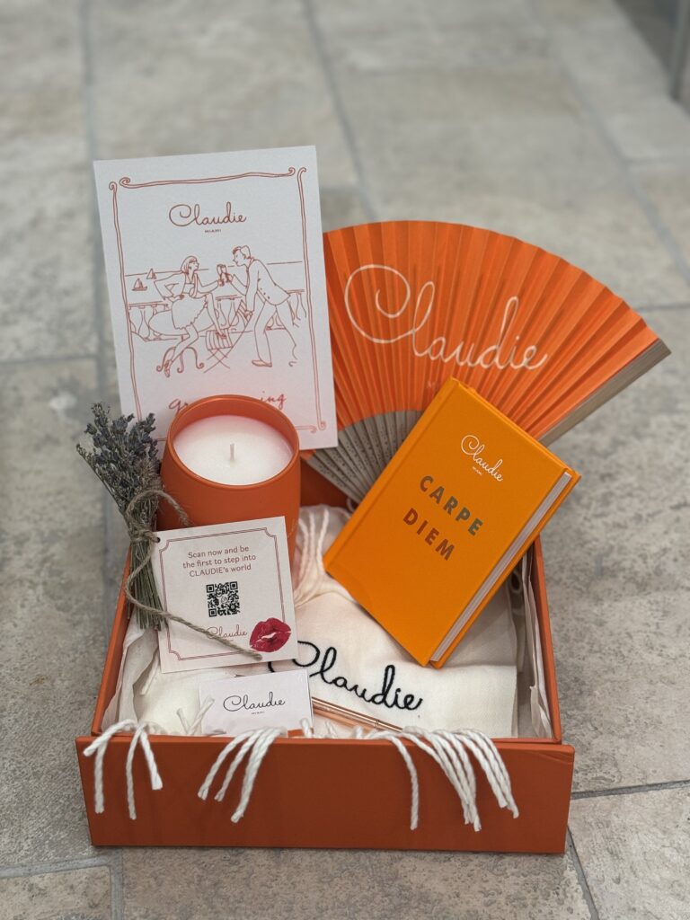 Gift box with different items, candle, fan, and more.